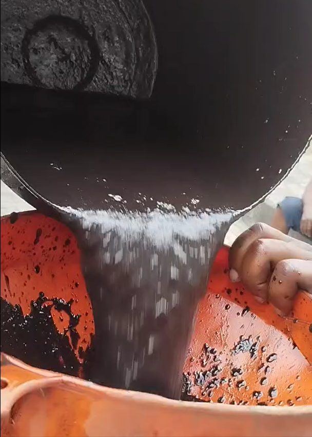 Tank sludge being decanted into drums for controlled disposal